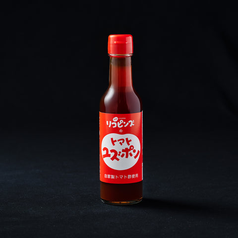 Red bottle of tomato ponzu on a black background