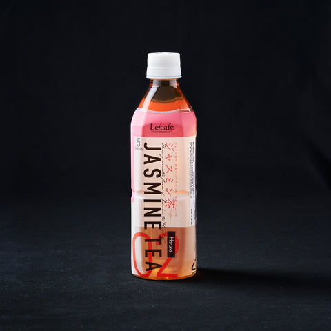 Bottle of chilled jasmine tea on a black background