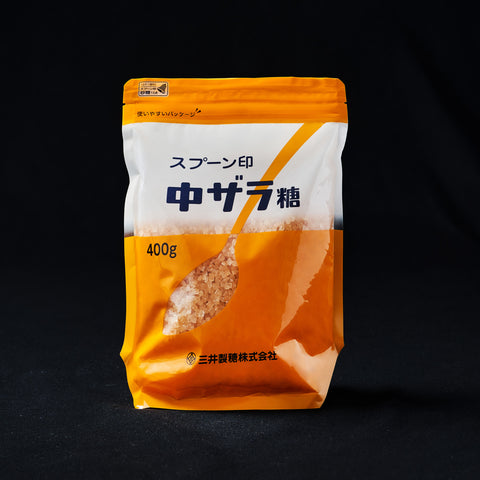 Bag of Crystallised Brown Sugar on a black background