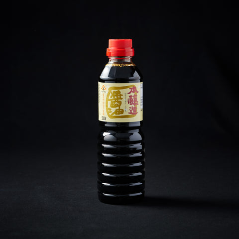Bottle of dark soy sauce on a black background
