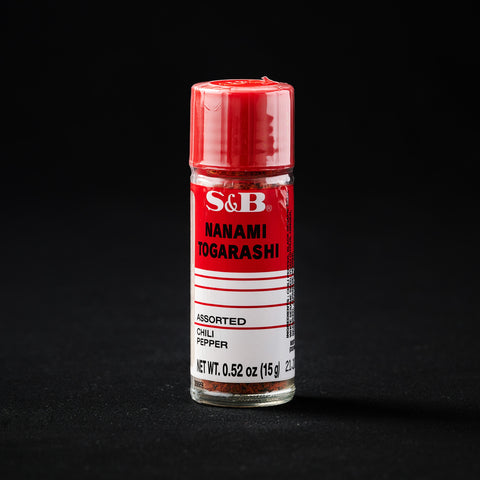 Spice jar of Shichimi Togarashi on a black background
