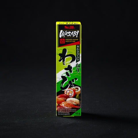 Box containing a tube of wasabi paste on a black background