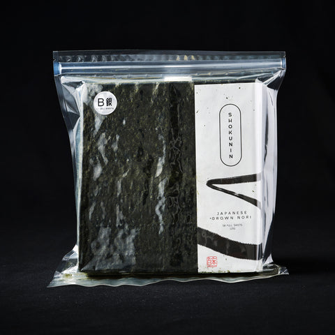 A pack of 50 Nori sheets on a black background