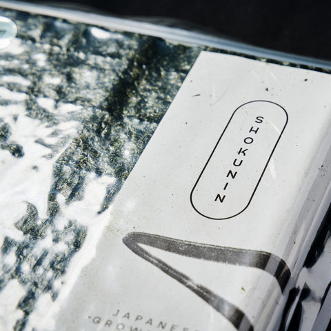 Close up of o pack of Nori sheets on a black background