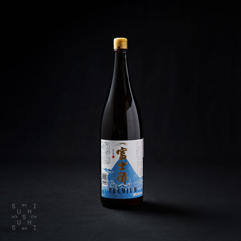 Black bottle of premium rice vinegar on a black background