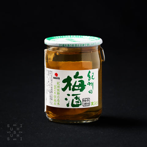84ml Cup of umeshu with a whole plum inside with a black background