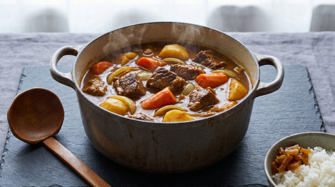 Large restaurant-style pot of Japanese curry with vegetables and meat