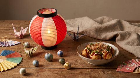 Japanese lantern and paper decorations beside festival food