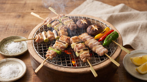 Yakitori skewers grilling over a konro charcoal grill