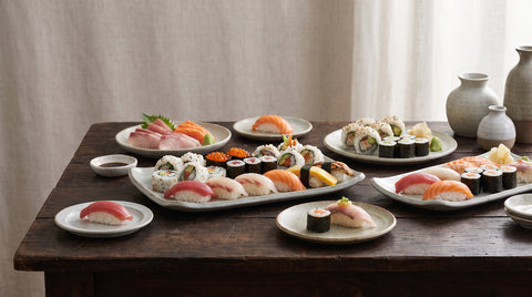 Spread of varied sushi platters with nigiri maki and sashimi