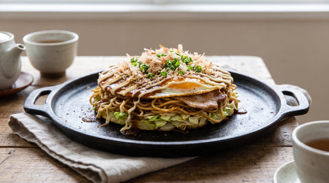 Thick Hiroshima-style okonomiyaki pancake with noodle layers