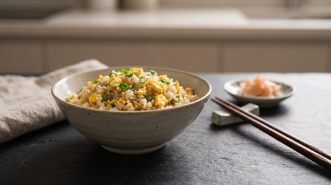 A bowl of cha-han Japanese fried rice with egg and spring onion, editorial food photography
