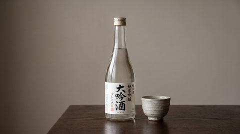 Elegant bottle of premium Japanese sake with a ceramic cup