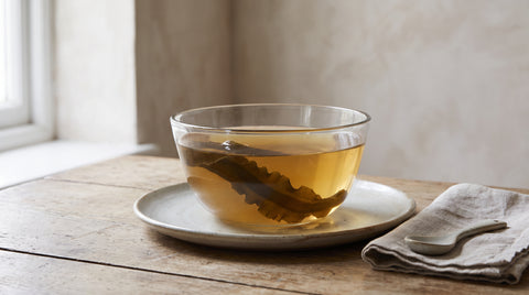 Clear bowl of kombu dashi broth with kombu seaweed