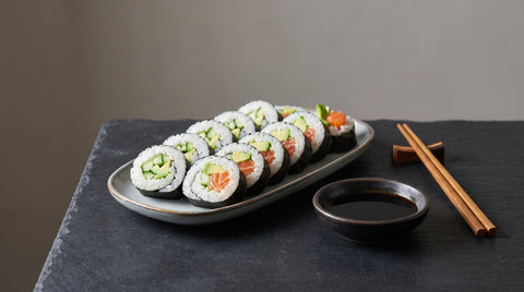 Platter of fresh sliced maki sushi rolls with soy sauce