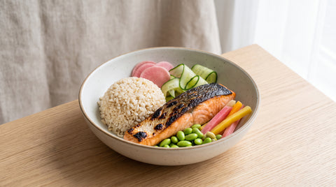 Healthy bowl of Japanese-style food with brown rice, salmon and edamame