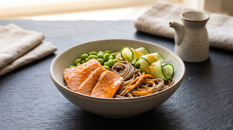 Lightly seared salmon with edamame soba noodle salad and orange ponzu, editorial food photography