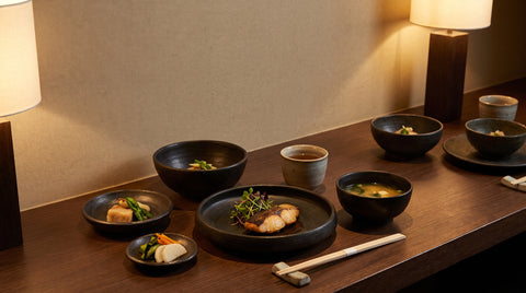 Japanese restaurant-style table setting with a plated multi-course meal