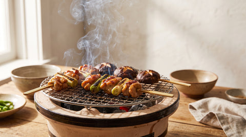 Yakitori skewers grilling over a traditional konro charcoal grill