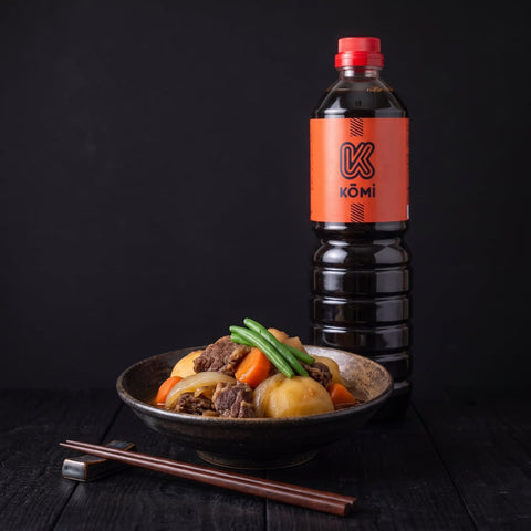 Nikujaga beef and potato stew with a 1 litre bottle of Kōmi dark soy sauce behind