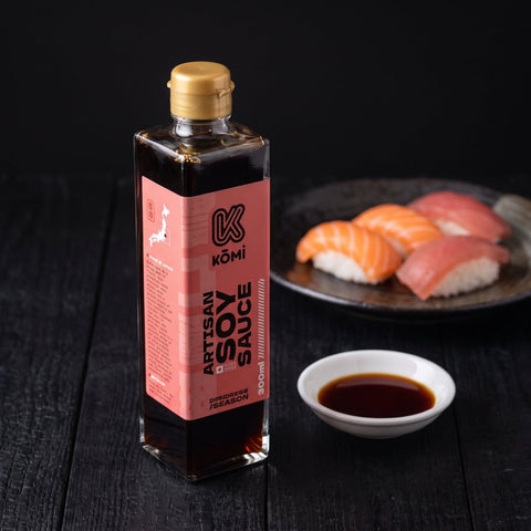 Kōmi Artisan soy sauce 300ml bottle with nigiri and a dish of soy, three-quarter view