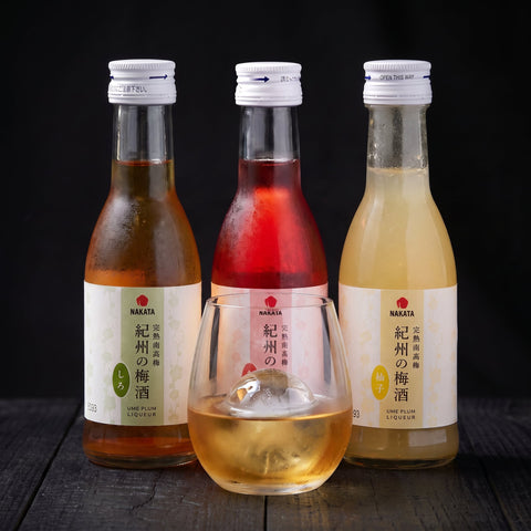 Nakata umeshu trio white, red and yuzu plum wine, three 180ml bottles with a glass on ice in front