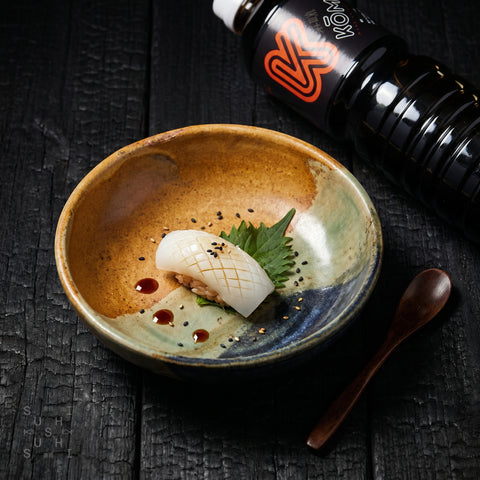 Kōmi gluten-free tamari soy sauce poured into a dish