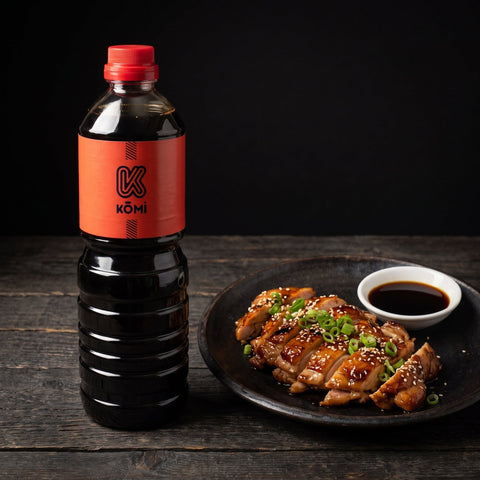 Kōmi dark soy sauce 1 litre bottle with chicken teriyaki and a dish of soy