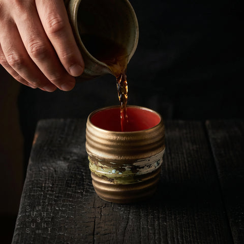 Gold rustic ceramic cup with brush-stroke detail