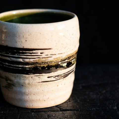 White-cream handleless Japanese ceramic cup, side view