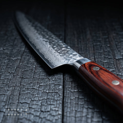 Close-up of the hammered Damascus blade and handle of the Sakai Takayuki 150mm petty knife