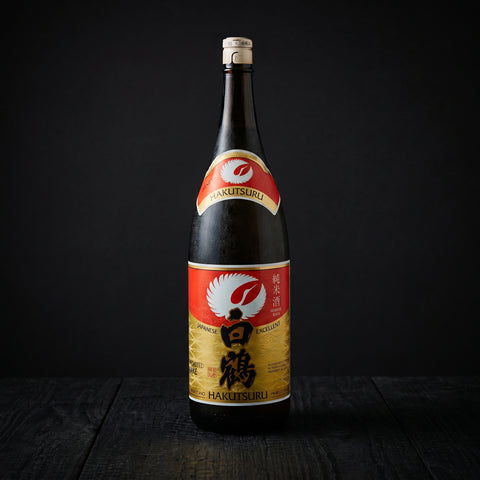 Hakutsuru Excellent Junmai sake served in a cup beside the bottle