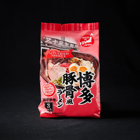 Red packet of noodles on a black background
