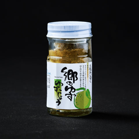 Jar or Green Yuzu Kosho on a black background
