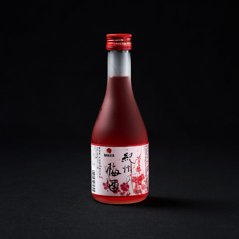 300ml bottle of red umeshu on a black background