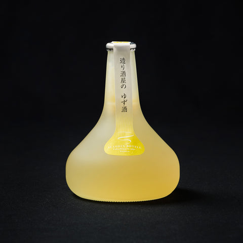 300ml bottom heavy bottle of Homare Yuzu Sake, Aladdin Bottle on a black background