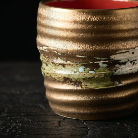 Gold-glaze Japanese rustic ceramic cup, side view