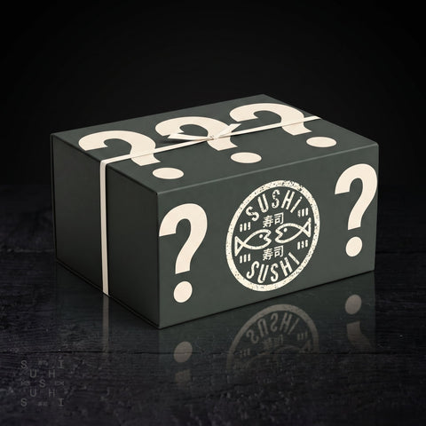 SushiSushi Japanese food mystery box worth £75 retail gift box with question marks, three-quarter view on dark wood