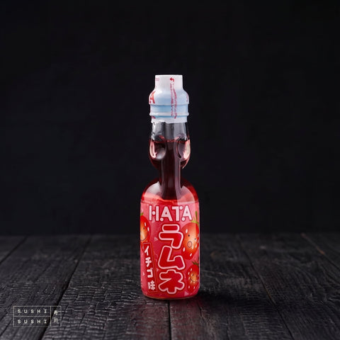 Hata Strawberry Ramune 200ml, bottle on charred shou sugi ban wood