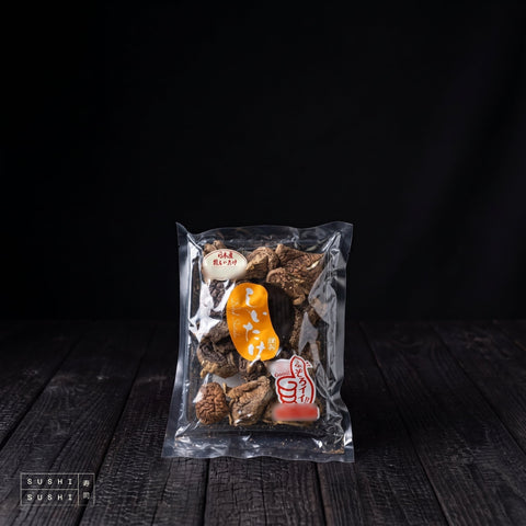 Japanese, Dried Shiitake Mushrooms, 40g, vacuum pack on charred shou sugi ban wood against a black backdrop