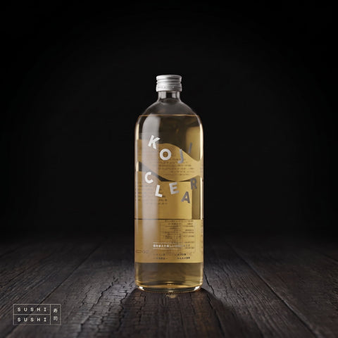 Koji Clear Non-Alcoholic Rice Koji Drink, 700ml, bottle on charred shou sugi ban wood against a black backdrop