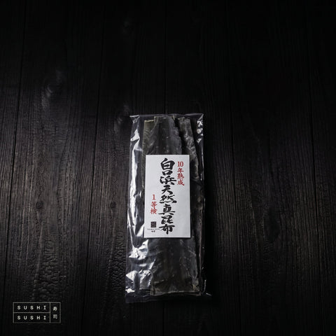 Kōmi, Ma Kombu, 10-Year Aged White Bay (Shiroikuchihama), 500g, pack lying on charred shou sugi ban wood