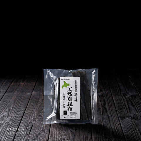 Kōmi, Ma Kombu, 3-Year Aged Black Bay (Kurokuchihama), 50g, pack on charred shou sugi ban wood against a black background