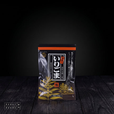 Kuki, Deep Roast, Premium Black Sesame Seeds, 65g, pouch on charred shou sugi ban wood against a black backdrop