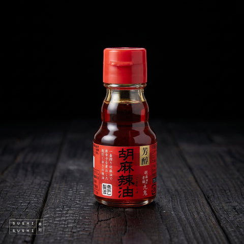 Kuki, Premium La Yu Chilli Oil, 45ml, bottle on charred wood