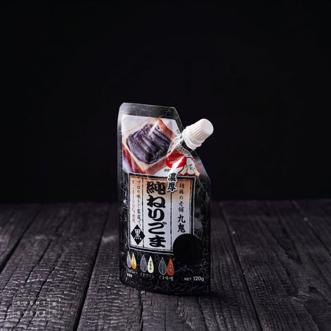 Kuki, Roasted Black Sesame Paste, 120g, spouted pouch on charred shou sugi ban wood