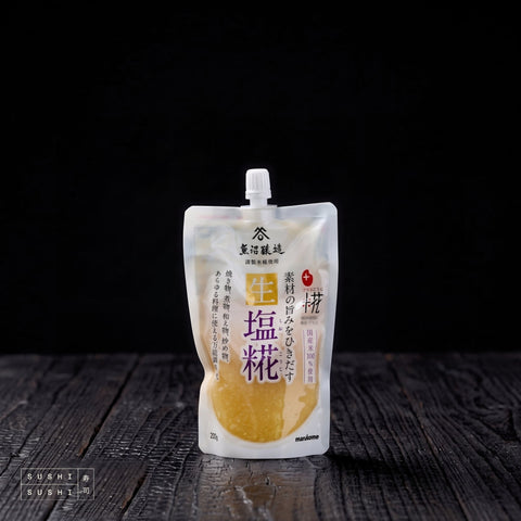 Marukome, Nama Shio Koji, Cultured Rice Seasoning, 200g, pouch on charred shou sugi ban wood against a black background