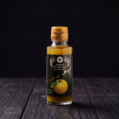 Oyama, Yuzu Kosho Hot Sauce, 100ml, bottle on charred shou sugi ban wood against a black backdrop
