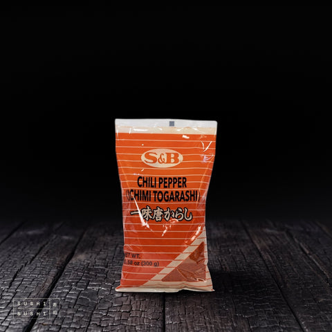 S&B 1 Spice Ichimi Togarashi 300g, bag on a charred shou sugi ban wooden surface against a black background