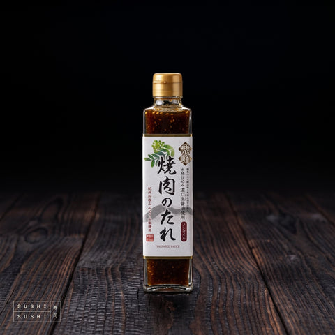 Shibanuma, Yakiniku Sauce, 360ml, bottle on a charred shou sugi ban wooden surface against a black background